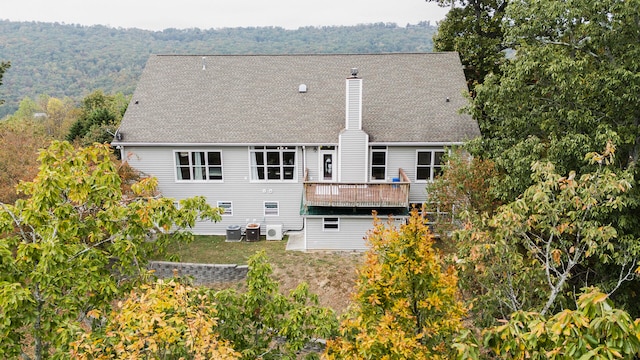 back of house with central AC and a deck