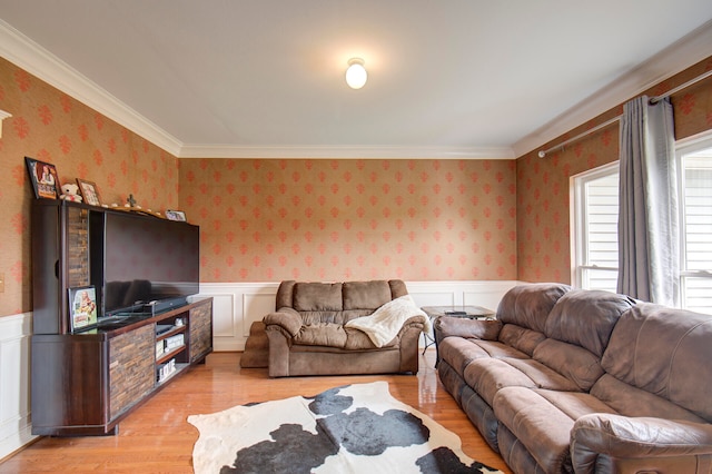 living room with crown molding and light hardwood / wood-style floors