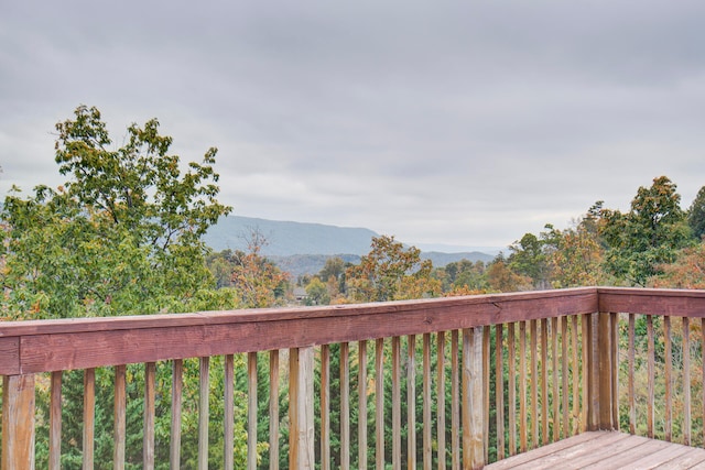 wooden deck with a mountain view