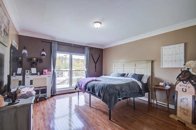 bedroom featuring ornamental molding and hardwood / wood-style floors