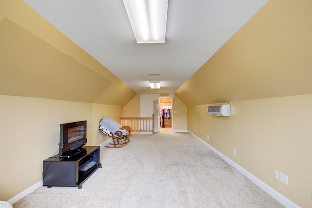 additional living space featuring a wall mounted AC, carpet flooring, and lofted ceiling