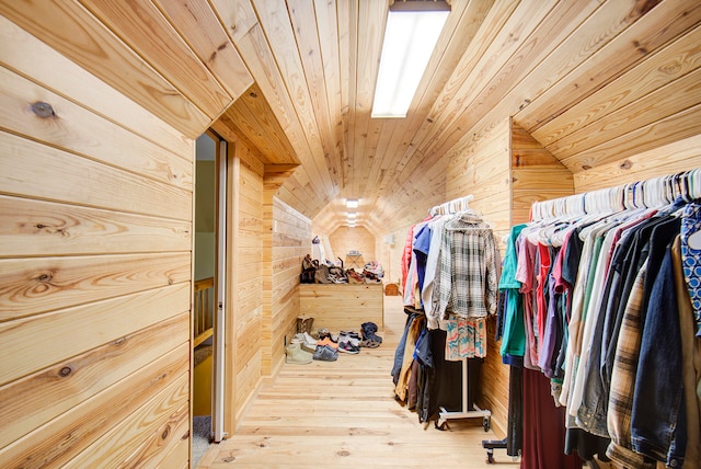 spacious closet with vaulted ceiling and hardwood / wood-style floors