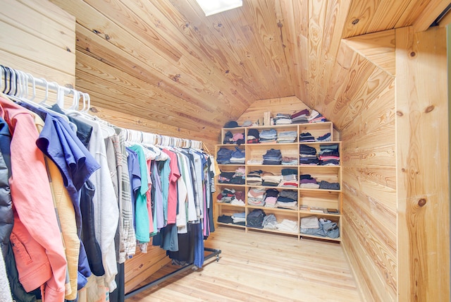 walk in closet featuring lofted ceiling and wood-type flooring