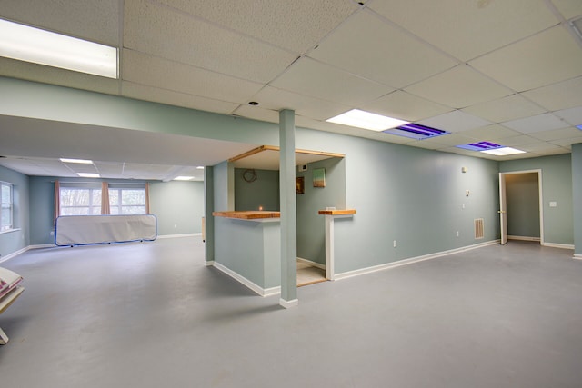 basement featuring a drop ceiling