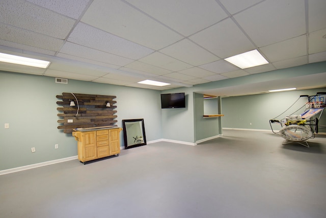 basement with a paneled ceiling