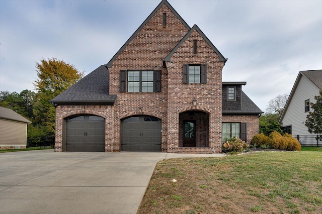 view of front of home with a garage and a front lawn