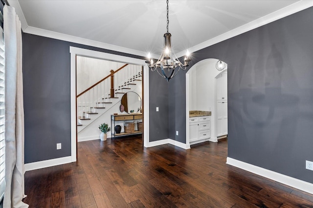 dining area featuring ornamental molding, a chandelier, and dark wood-type flooring