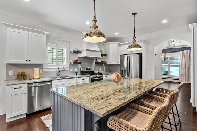 kitchen with sink, a center island, stainless steel appliances, white cabinets, and dark hardwood / wood-style floors