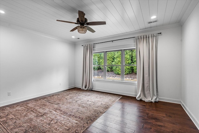 empty room with dark wood-type flooring, wood ceiling, crown molding, and ceiling fan