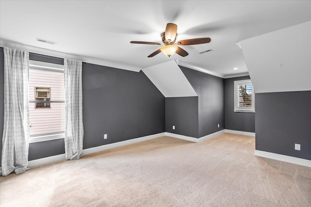 additional living space featuring lofted ceiling, light colored carpet, and ceiling fan