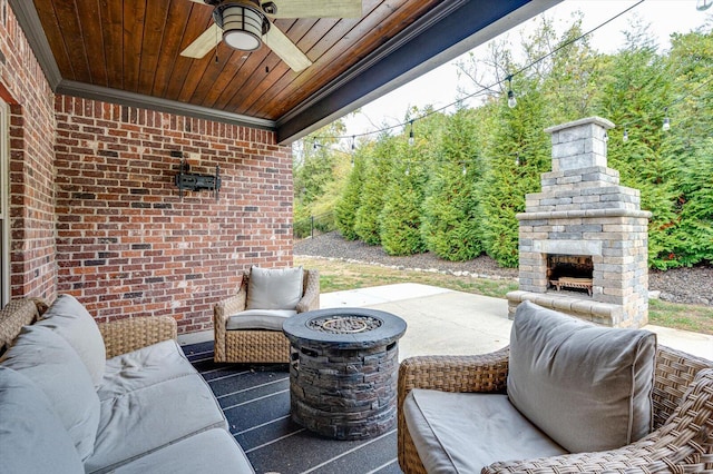 view of patio / terrace with an outdoor living space with a fireplace and ceiling fan