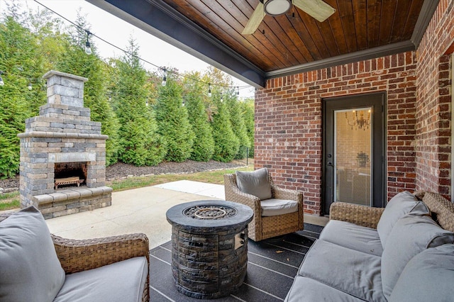 view of patio with an outdoor living space with a fireplace and ceiling fan