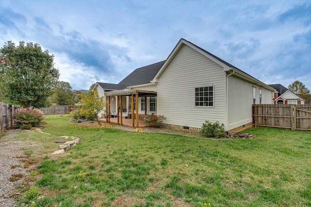 back of house with a yard and a patio area