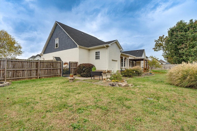 rear view of house with a yard