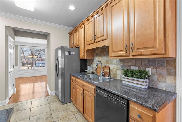 kitchen featuring sink, tasteful backsplash, ornamental molding, stainless steel fridge, and dishwasher