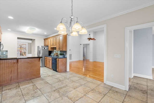 kitchen featuring a breakfast bar, ornamental molding, appliances with stainless steel finishes, pendant lighting, and ceiling fan with notable chandelier