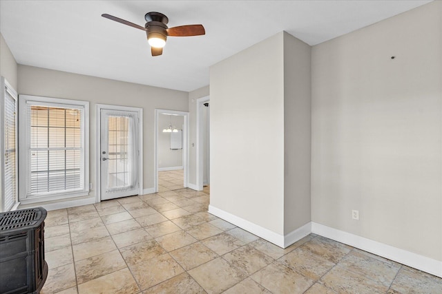 empty room with heating unit and ceiling fan