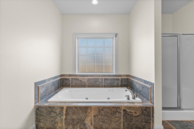 bathroom featuring tiled tub