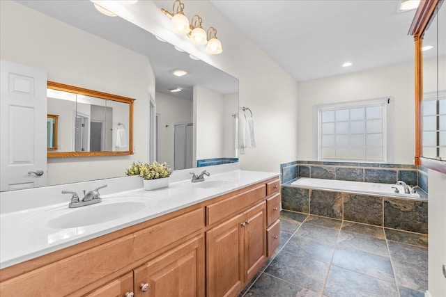 bathroom with a relaxing tiled tub and vanity