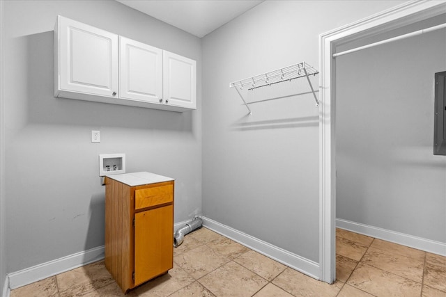 clothes washing area featuring hookup for a washing machine, electric panel, and cabinets