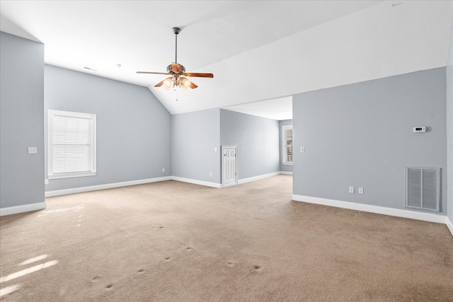 interior space featuring vaulted ceiling, light colored carpet, and ceiling fan