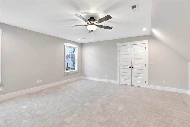 unfurnished bedroom featuring carpet, recessed lighting, baseboards, lofted ceiling, and visible vents