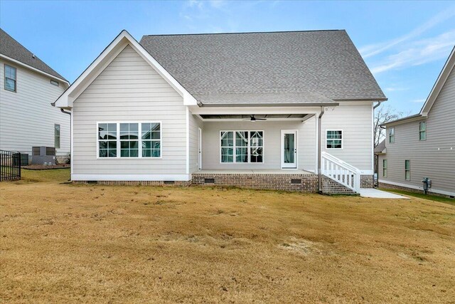 rear view of house with a lawn, a ceiling fan, central AC unit, and crawl space