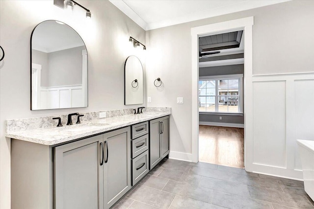 bathroom with vanity, ornamental molding, and wood-type flooring