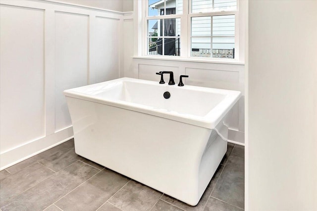 bathroom with tile patterned flooring and a decorative wall