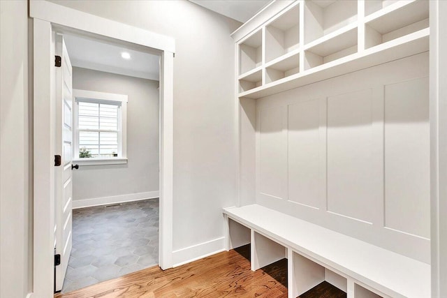 mudroom with baseboards and wood finished floors