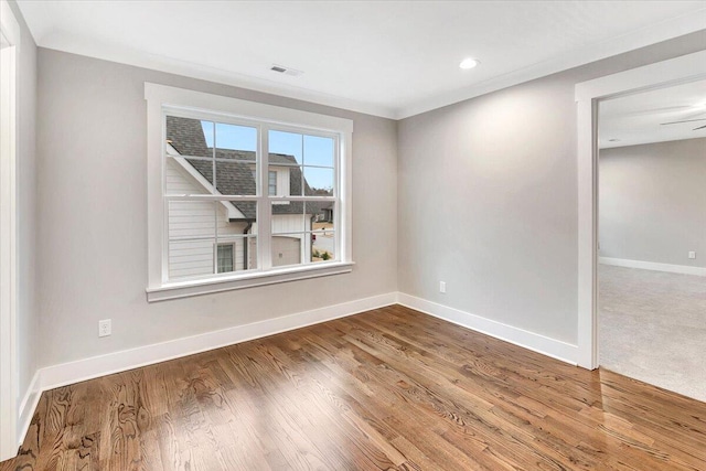 spare room featuring visible vents, recessed lighting, baseboards, and wood finished floors