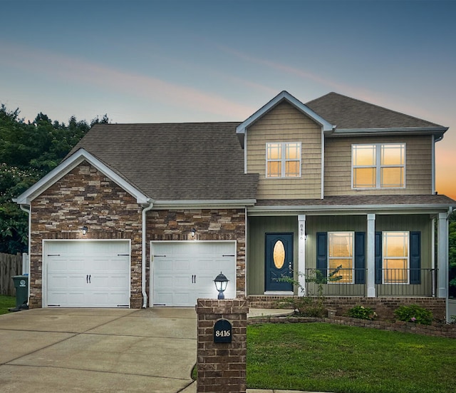 craftsman-style house featuring a yard, a garage, and a porch