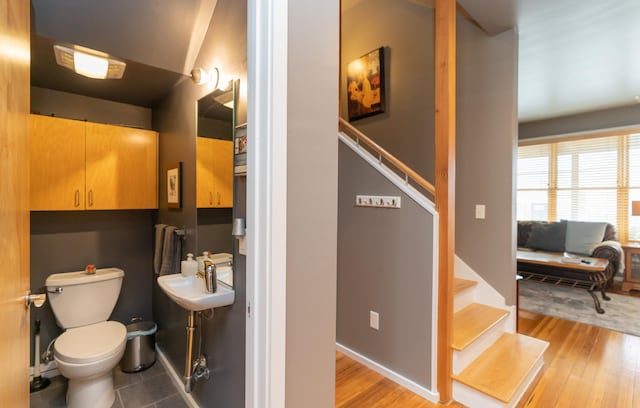 bathroom with sink, hardwood / wood-style floors, and toilet