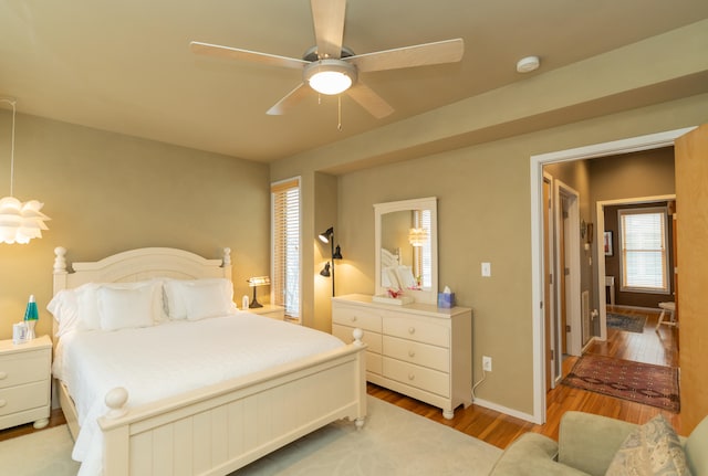 bedroom with light hardwood / wood-style flooring and ceiling fan