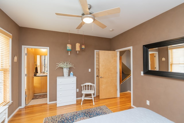 bedroom with sink, ensuite bathroom, light hardwood / wood-style flooring, and ceiling fan