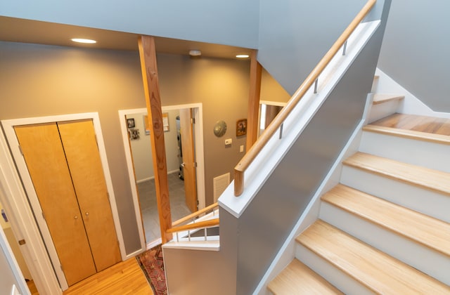 stairs featuring hardwood / wood-style floors