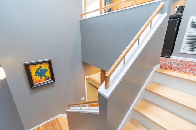 staircase with hardwood / wood-style flooring