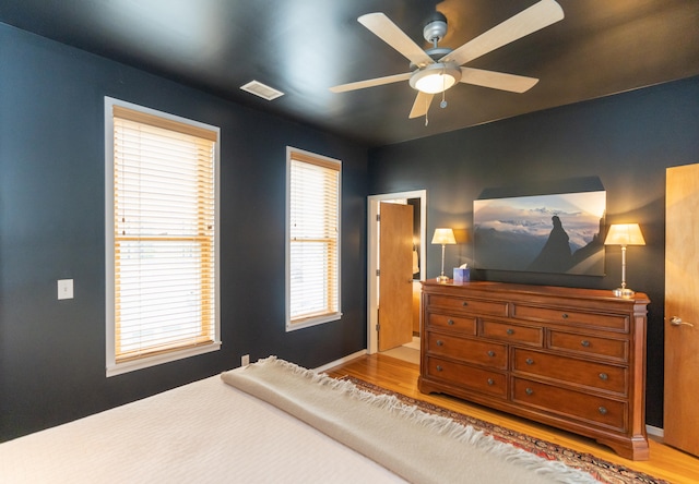 bedroom with hardwood / wood-style floors and ceiling fan