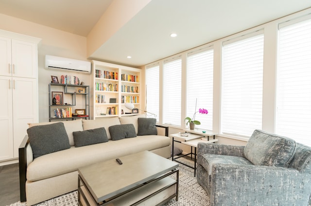 living room featuring a wall mounted air conditioner and a healthy amount of sunlight