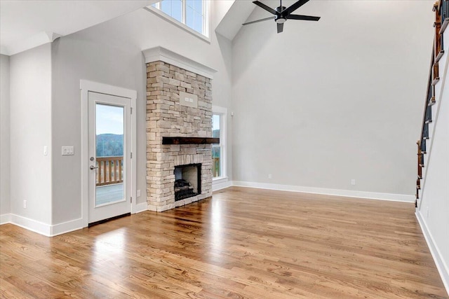unfurnished living room featuring high vaulted ceiling, ceiling fan, and a wealth of natural light