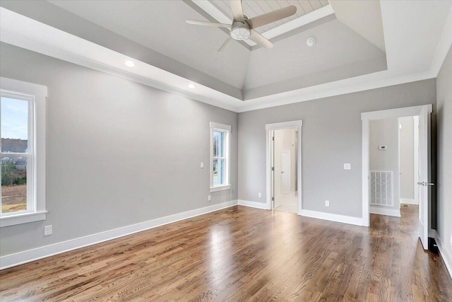 empty room featuring crown molding, a healthy amount of sunlight, wood-type flooring, and ceiling fan