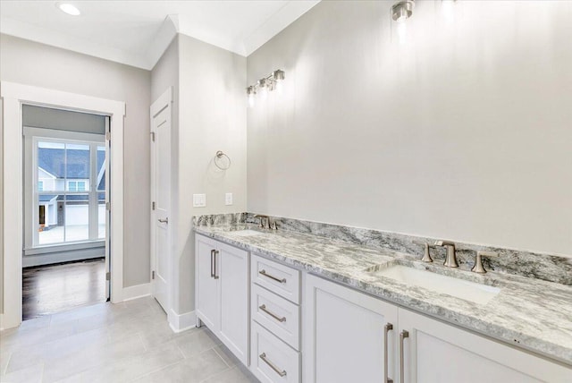 bathroom with vanity, ornamental molding, and tile patterned flooring