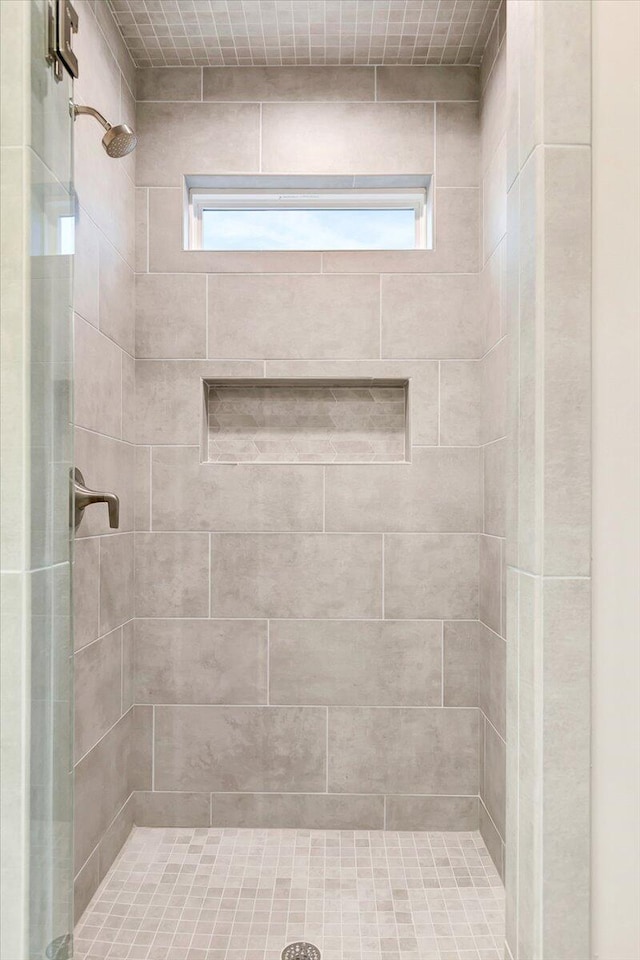 bathroom with a tile shower