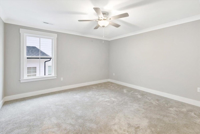 spare room featuring crown molding, carpet, and ceiling fan