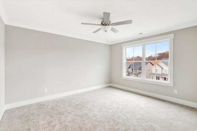 carpeted spare room with crown molding and ceiling fan