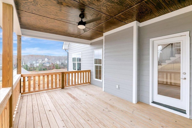 wooden deck featuring a mountain view and ceiling fan