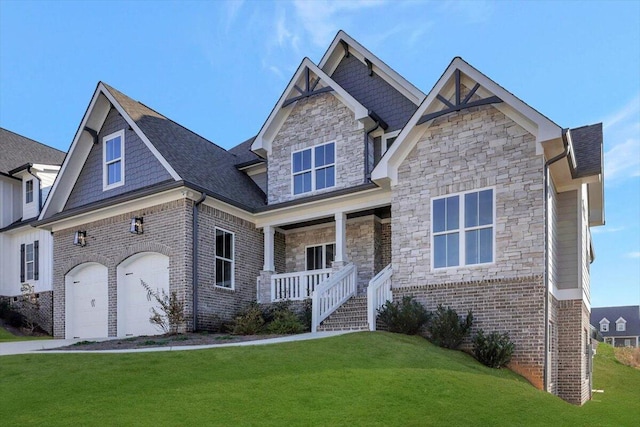 craftsman-style house with covered porch, brick siding, a front lawn, and stone siding