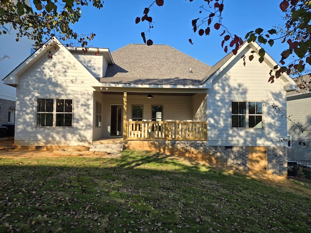 back of house with a lawn and covered porch