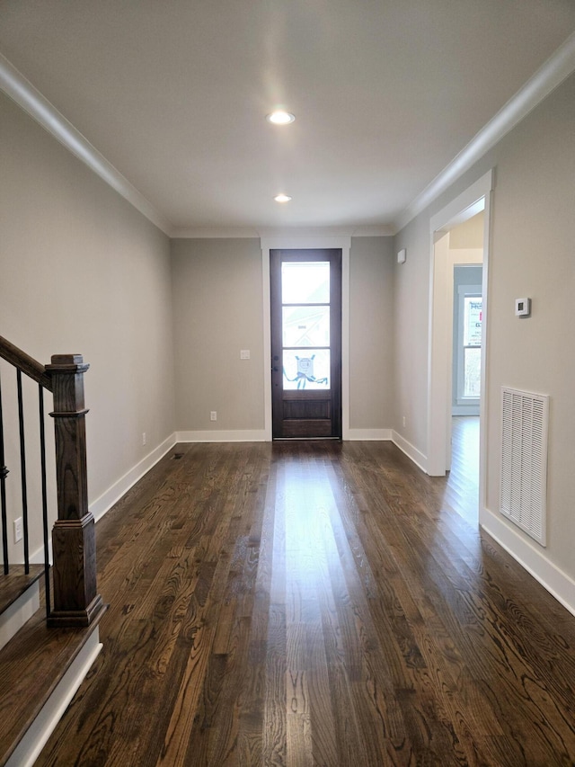 entryway with crown molding and dark wood-type flooring