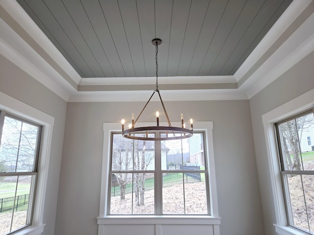 room details with a chandelier, a raised ceiling, crown molding, and wood ceiling